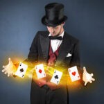 Illusionist in tails bandy play cards between his two hands